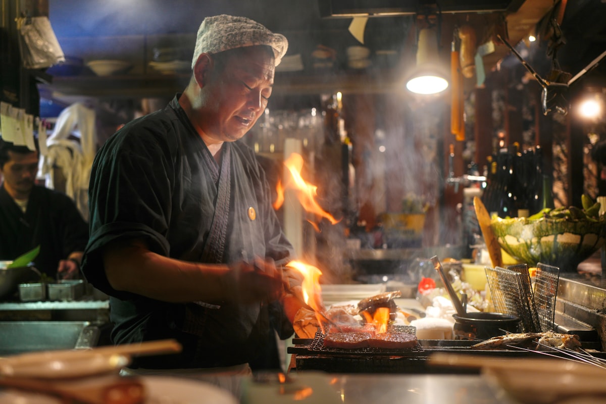 Chef cooking over open flame in the kitchen