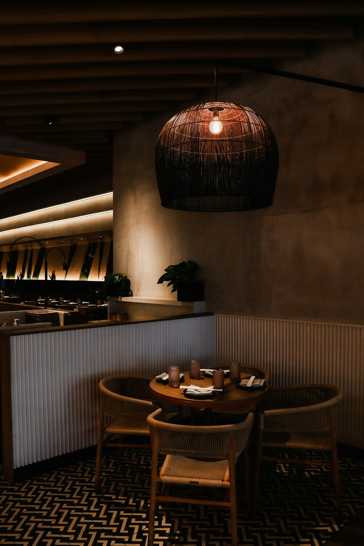 Round table with rattan pendant light in the dining room